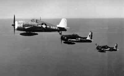 Two F8F "chase" planes shepherd an F6F-5K 