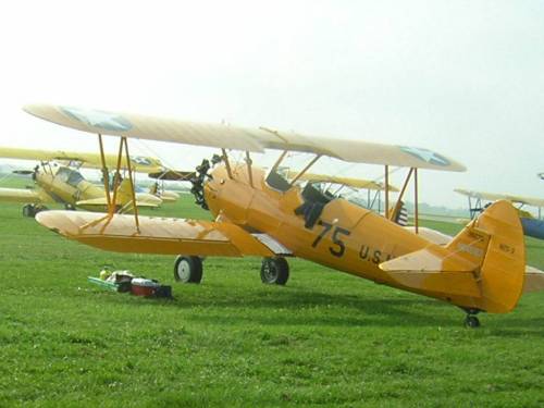 The Navy N2S Stearman primary flight training plane, typically painted yellow, is shown at a 'fly-in' in Galesburg Illinois, pretty much as it was configured for trainee pilots in the early 1940s.