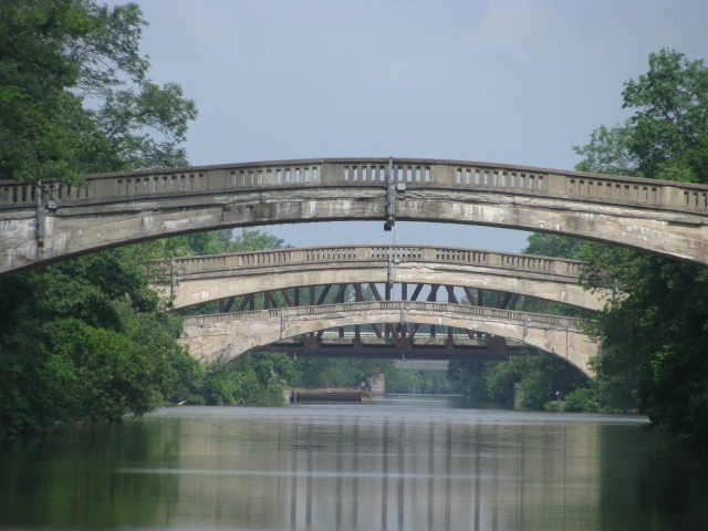 Pedestrians cross Erie Canal on bridge near the Genesee River at Rochester NY.