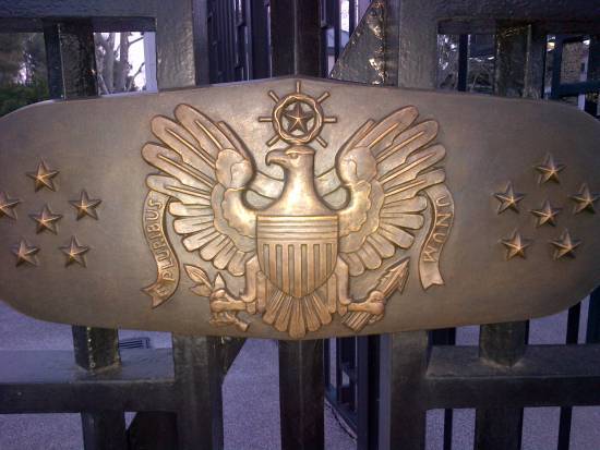 Coat of arms on closed gate of Rhone American cemetery at Draguignan France